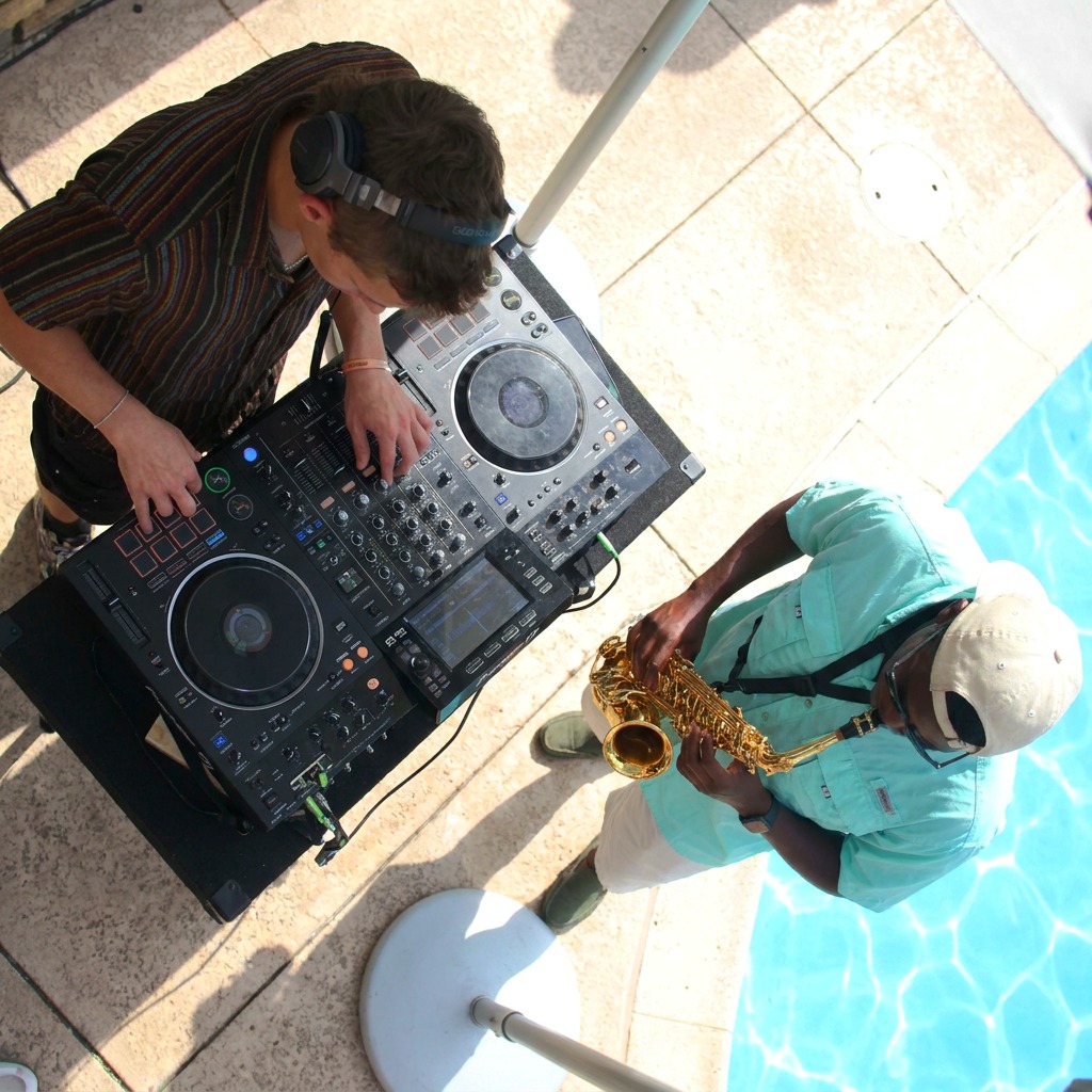 DJ and saxophone player performing together at a poolside party